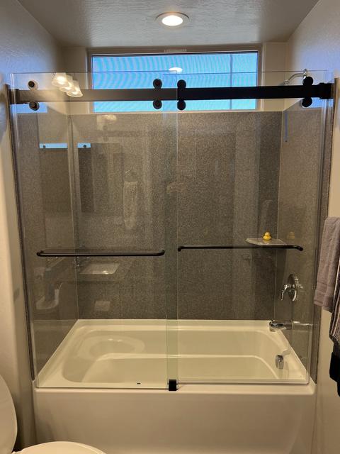 Bypass barn door over a tub · Matte black