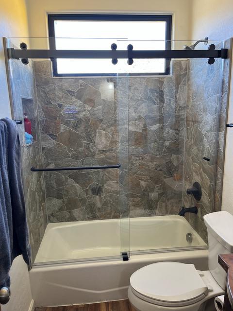 Barn-style slider over a tub · Matte black