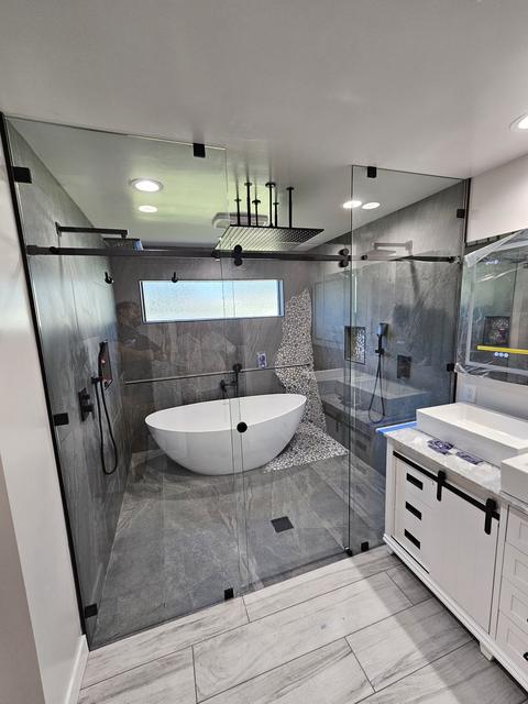 Wet-room enclosure around shower and tub · Matte black