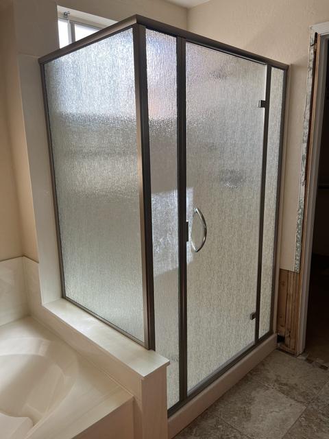 Framed rain-glass corner · Brushed bronze