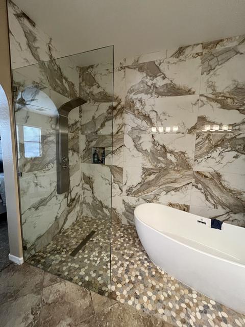 Walk-in splash panel beside a tub