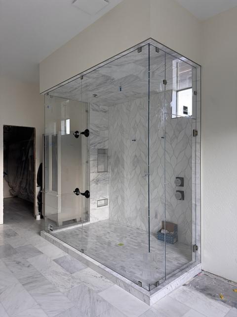 Floor-to-ceiling glass enclosure · Matte black